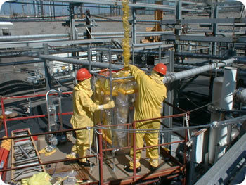 Photo of Savannah River Site tank workers in yellow protective clothing